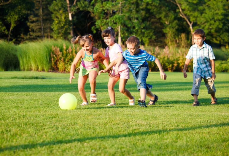 Children playing soccer on artificial grass in North Carolina