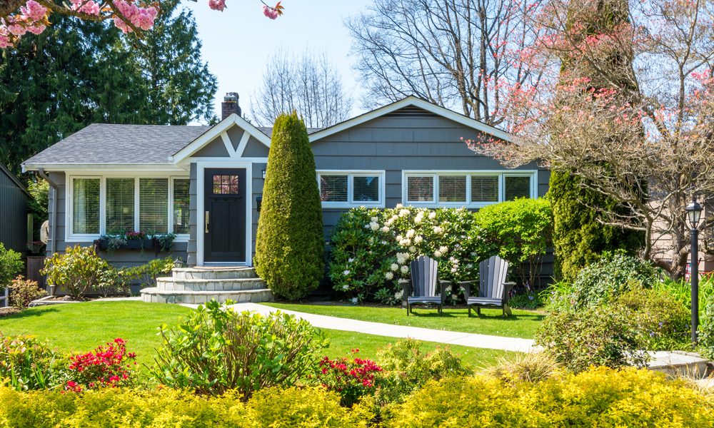 Cozy home exterior with a beautiful lawn and landscaping.