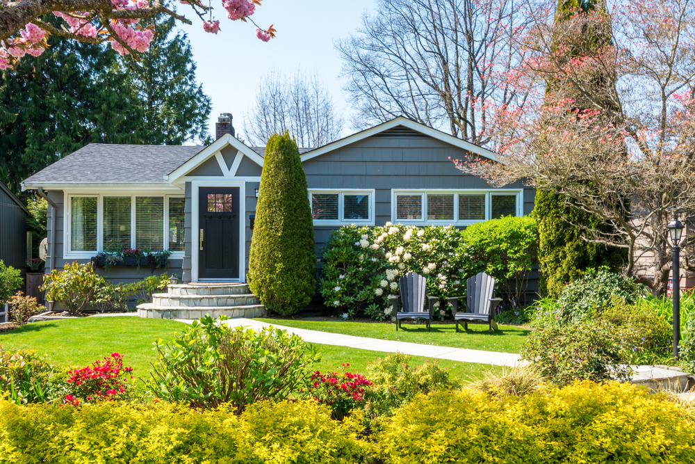 Cozy home exterior with a beautiful lawn and landscaping.