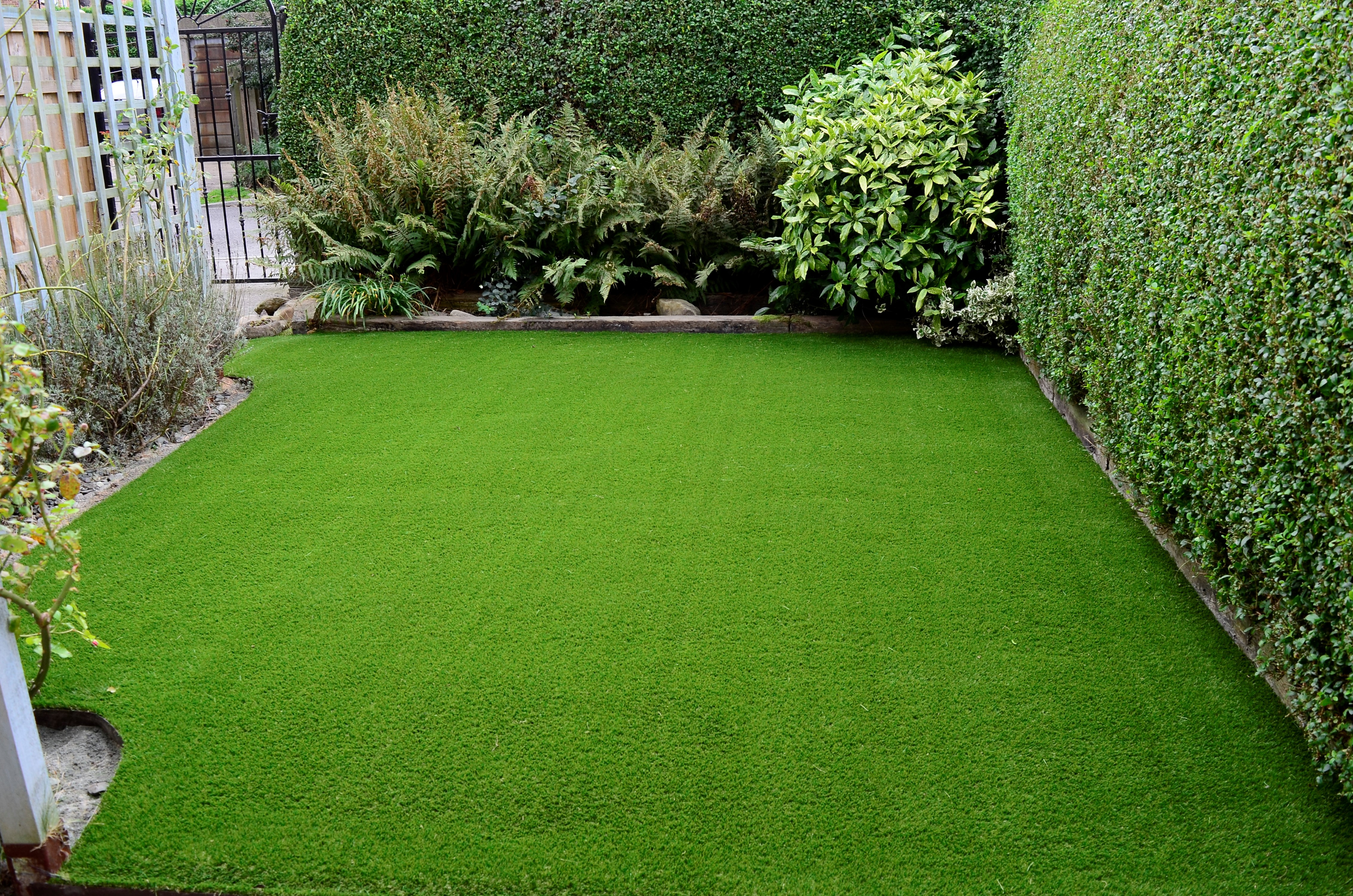 Artificial grass lawn with foliage
