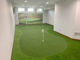 Indoor putting green with mural