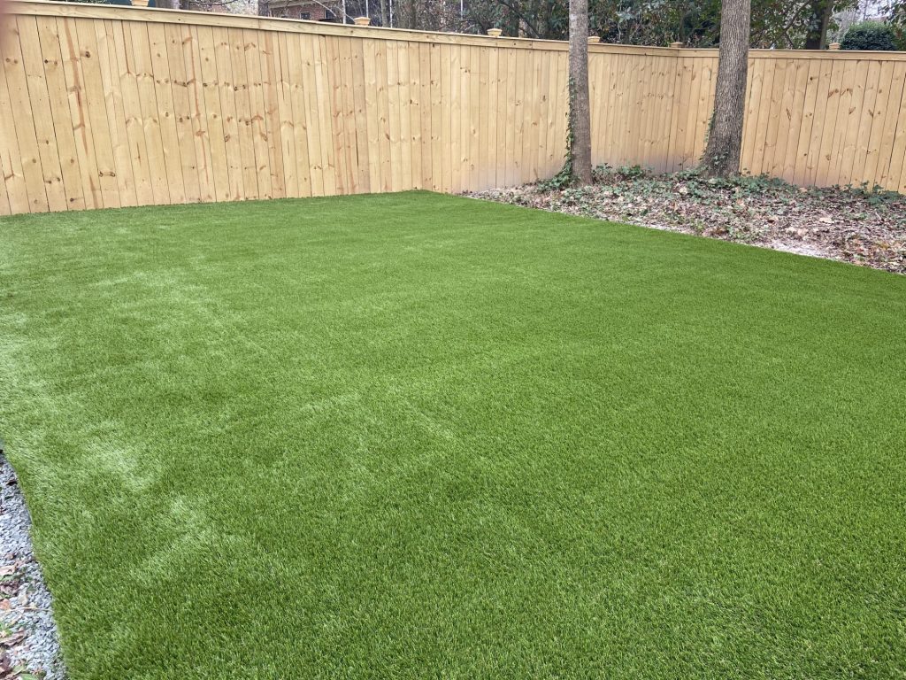 artificial grass backyard with woodfence