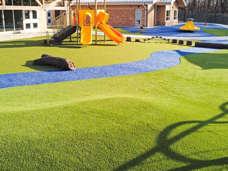 Artificial playground turf with commercial playground equipment